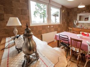 a living room with a table and a dining room at Chalet in Raon-l'Étape near Lake in Raon-lʼÉtape