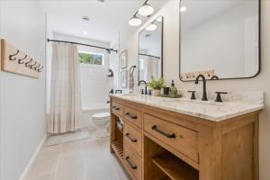 a bathroom with a sink and a toilet and a mirror at Modern Paradise In The Forest - Bruce Peninsula in Stokes Bay +51 photos