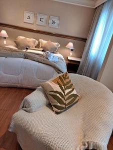 a bedroom with two beds with pillows on it at Conforto Flat Hotel Vila Olimpia in São Paulo