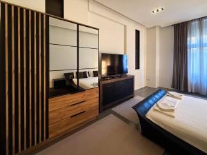 a hotel room with a bed and a large mirror at City Center Apartment in Belgrade