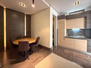 a dining room with a wooden table and chairs at City Center Apartment in Belgrade