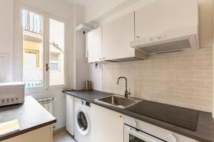 eine Küche mit Spüle und Waschmaschine in der Unterkunft GuestHost - Ponte Vecchio Charming Apartments in Florenz