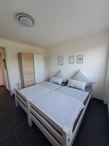 a bedroom with a large bed with blue sheets at FeWo Müller in Simmersfeld