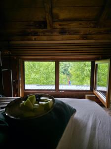 a plate of fruit on a bed in front of a window at Gaga vikendica in Lukovo