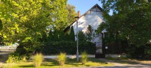 a small chapel with a street light in front of it at Balatonka Apartman in Alsóörs