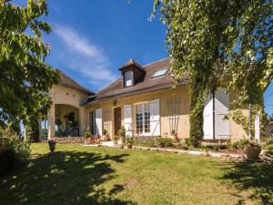 an exterior view of a house with a yard at Villa with Pool in Corrèze in Saint-Bonnet-la-Rivière