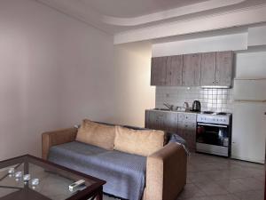 a living room with a couch and a kitchen at PORT MARIN a in Livadi