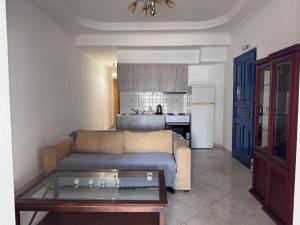 a living room with a couch and a kitchen at PORT MARIN a in Livadi