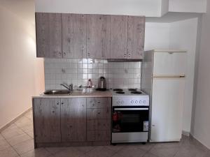 a kitchen with a stove and a refrigerator at PORT MARIN a in Serifos Chora +3 photos