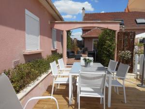 a white table and chairs on a patio at Holiday Home Folleville near Asterix Park in Sourdon +36 photos