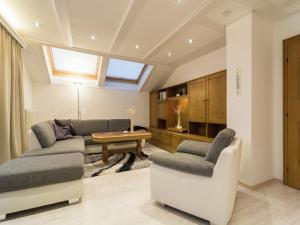 a living room with a couch and a table at Holiday Home in Rennweg near Ski Slopes in Rennweg