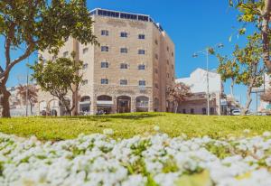 a building with white flowers in front of it at Agripas Boutique Hotel in Jerusalem
