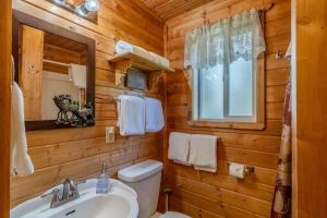 a bathroom with a sink and a toilet and a mirror at The Aspen House in West Yellowstone +27 photos