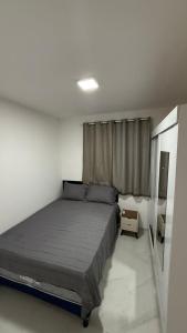 Ένα ή περισσότερα κρεβάτια σε δωμάτιο στο Casa nova e aconchegante em condomínio
