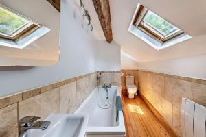 a bathroom with a tub and a sink and skylights at The Mountains House in Blaenau-Ffestiniog +20 photos