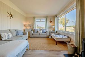 a living room with a bed and a couch and a table at Eryl in Ferryside