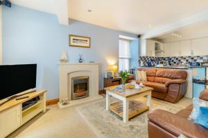 a living room with a couch and a fireplace at Seacove in Saundersfoot
