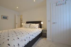 a bedroom with a large bed and a desk at The Old Chapel in Saundersfoot