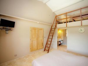 a bedroom with a bunk bed and a ladder at Villa in Provence with Infinity Pool in Martres-Tolosane