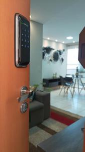 a door with a remote control in a living room at 8º Relax - Cama de Massagem! in Uberlândia +40 photos