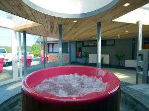 a red tub with snow inside of a house at Trooz Villa with Pool & Sauna in Trooz +32 photos