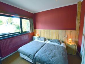a red bedroom with a bed and a window at Trooz Villa with Pool & Sauna in Trooz