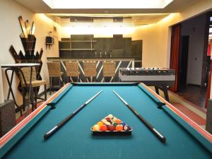 a pool table with cue balls on top of it at Trooz Villa with Pool & Sauna in Trooz