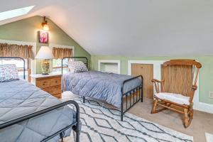 a bedroom with two beds and a chair at Quaint and Charming Cherry Valley Escape! in Cherry Valley