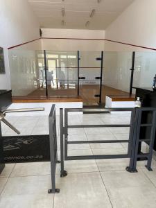 a glass wall in a room with a table at AlimamaSpaces Phillys Whisken in Midrand +19 photos
