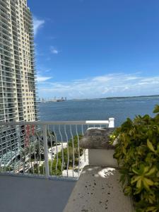 a balcony with a view of the ocean and buildings at Stunning view from 42nd floor, Brickell-Miami financial district free self-parking spot, sleeps 4 in Miami