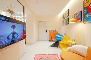a living room with a flat screen tv on a wall at Midas Seri Alam Luxury Dopamine Jacuzzi in Masai
