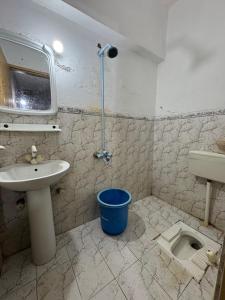 a bathroom with a sink and a toilet at Eden Plus Hotel-Garden Town in Lahore