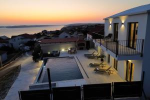a view of a house with a swimming pool at Newly built Villa MarVista with 4 bedrooms,infinity pool & stunning sea and mountain views in Rtina