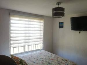 En eller flere senge i et værelse på Cabaña por Quintero