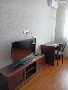 a flat screen tv sitting on top of a wooden entertainment center at Апартаменти ЖК Покровський двір Чабани in Chabany