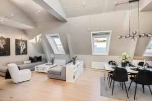 a large living room with a table and chairs at Two bedroom penthouse with large living room and rooftop in the city centre of Trondheim in Trondheim