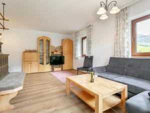 a living room with a couch and a table at Almruhe Alpbach in Alpbach