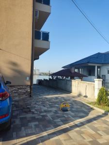 a car parked next to a building with a yellow ball at Apartman MODA in Kladovo