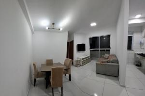 a living room with a table and a couch at AP a 3KM das PRAIAS, com SUÍTE in São Luís