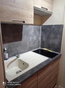 a kitchen with a sink and a counter at appartement super devoluy in Le Dévoluy