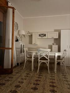 a kitchen with a table and chairs in a room at A casa di Rita in Toro