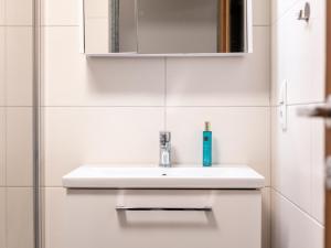 a white bathroom with a sink and a mirror at Am Bauernhof Top 2 in Alpbach +20 photos