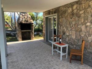 a stone house with a table and a stone oven at Suite's on the rock's in Nono