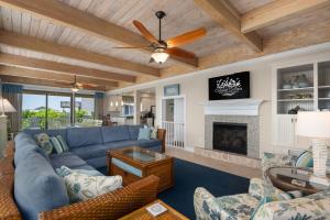 a living room with a blue couch and a fireplace at DK290 Point of View in Duck
