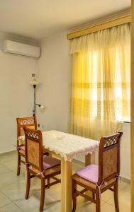 a dining room with a table and two chairs at Villa Anemos in Nivicë +9 photos