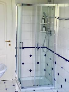 a shower with a glass door in a bathroom at Villa Oasi Mariuccia - Relax e Mare in Lido di Jesolo +16 photos