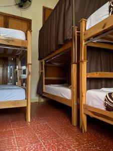 a room with three bunk beds in a room at ADVENTURE Hostel in San Gil