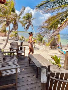 a woman in a bikini walking on the beach at Hotel xahuayxol in Mahahual +7 photos
