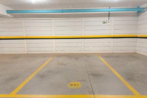 a garage with white and yellow garage doors and a frisbee at Veja Este Apê Completo! - PS505 in Maringá