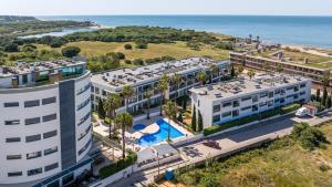 an aerial view of a resort with a pool and the ocean at Cavalo Preto Ocean Breeze Apartment in Forte Novo Quarteira in Quarteira